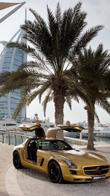 Image yellow ferrari 458 italia on road near palm trees during daytime