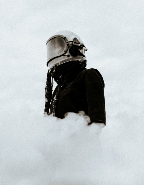 Image grayscale photo of man in black jacket and helmet