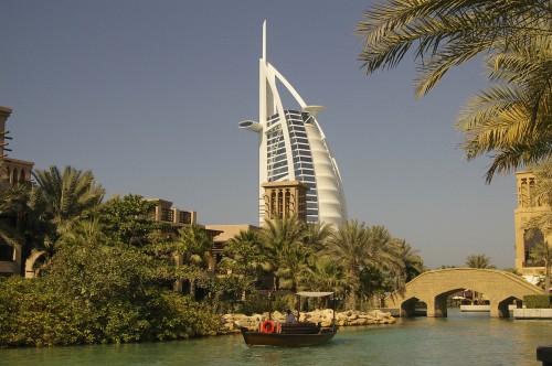 Image white and brown concrete building near body of water during daytime