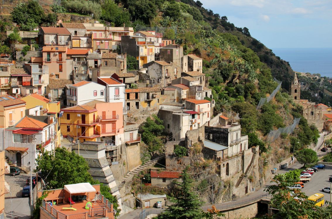 white and brown concrete houses on mountain