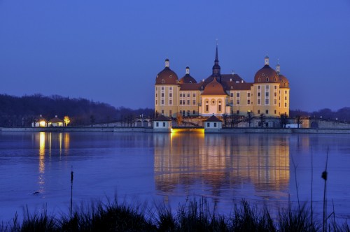 Image brown concrete building near body of water during night time