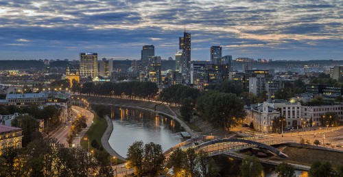 Image city skyline under blue sky during night time