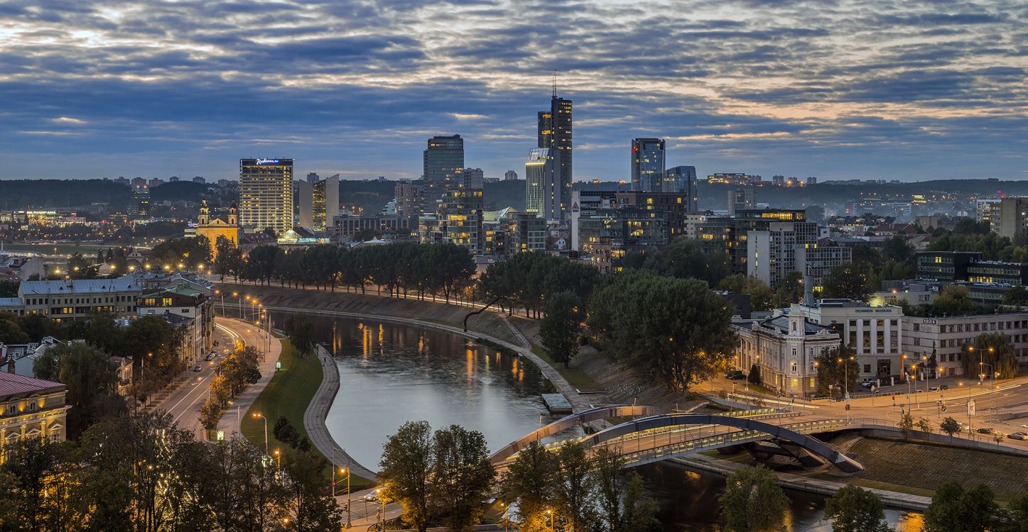 city skyline under blue sky during night time