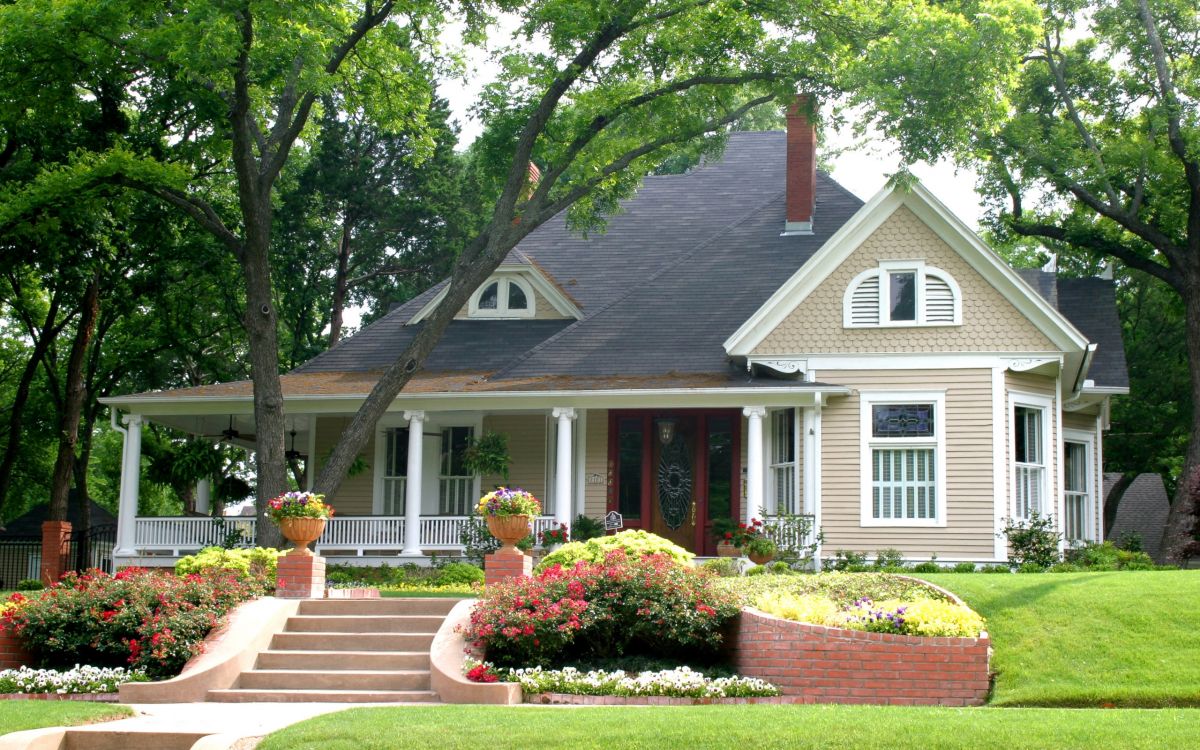 green trees near white and brown house during daytime