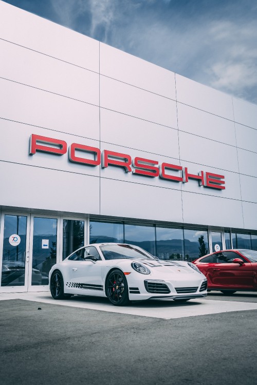 Image white porsche 911 parked in front of white building