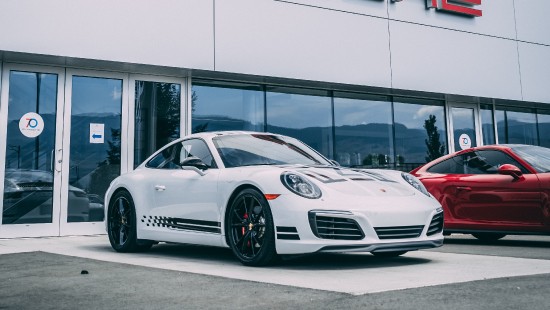 Image white porsche 911 parked in front of white building