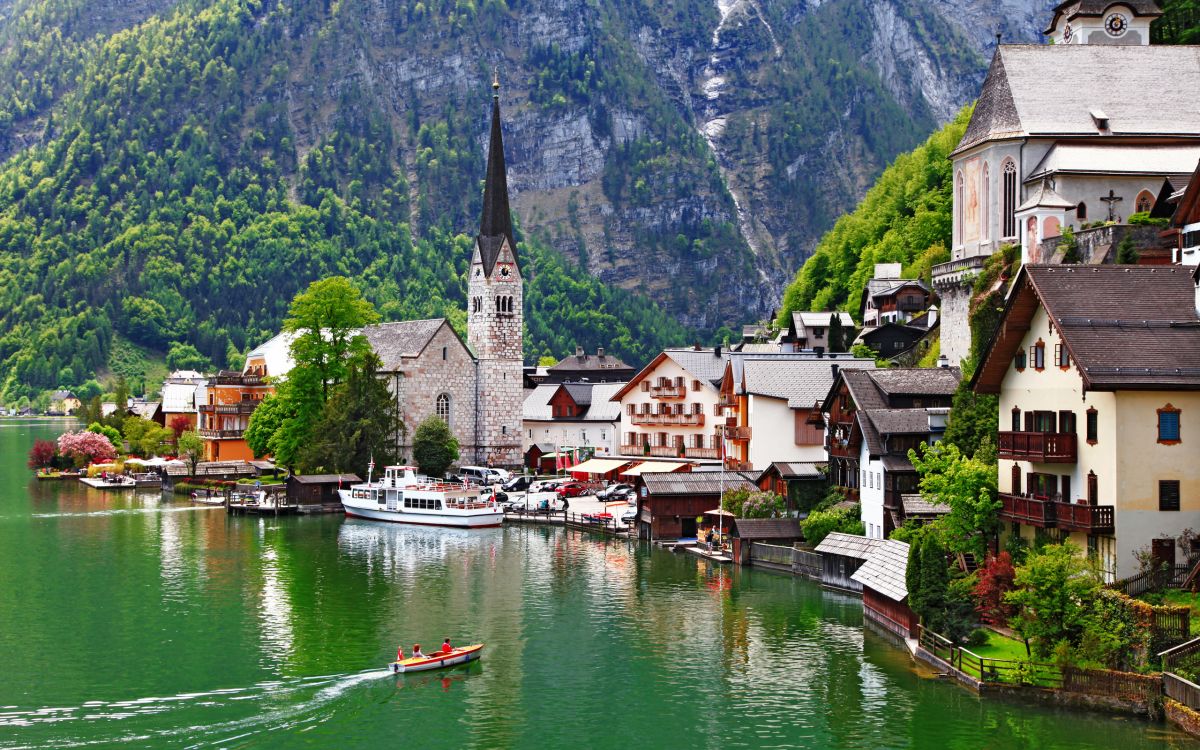 white and brown concrete building beside body of water during daytime