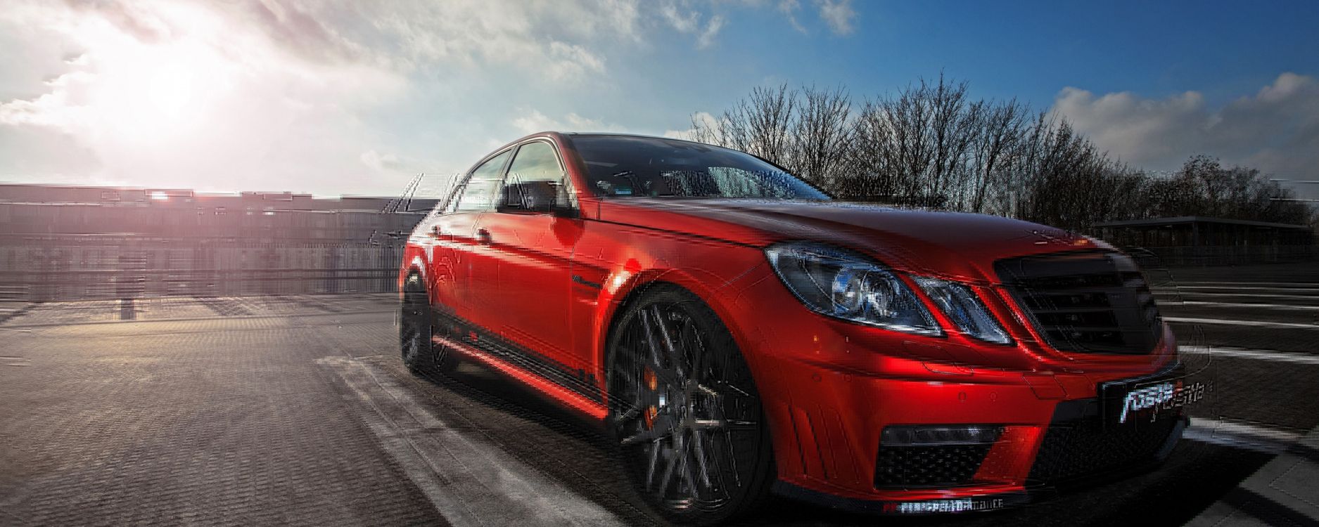 red sedan on gray asphalt road during daytime