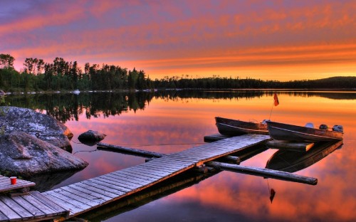 Image brown wooden dock on lake during sunset