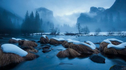 Image brown rock formation on body of water during daytime