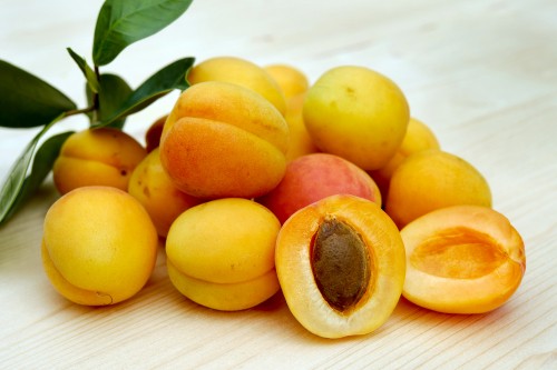 Image yellow round fruits on white table