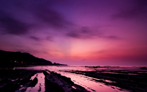 Image body of water under cloudy sky during sunset