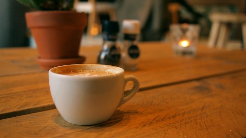 Image white ceramic mug on brown wooden table