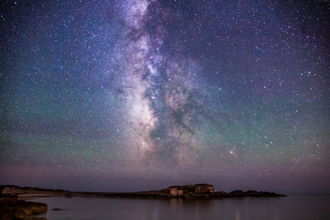 body of water under starry night