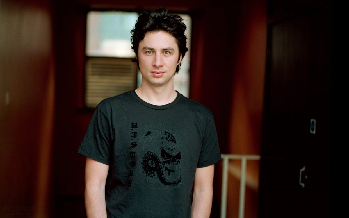 man in black crew neck t-shirt standing near red wall