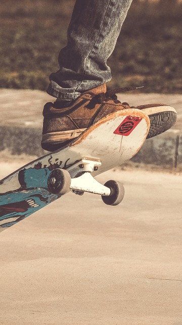 Image person in black pants and blue and white skateboard