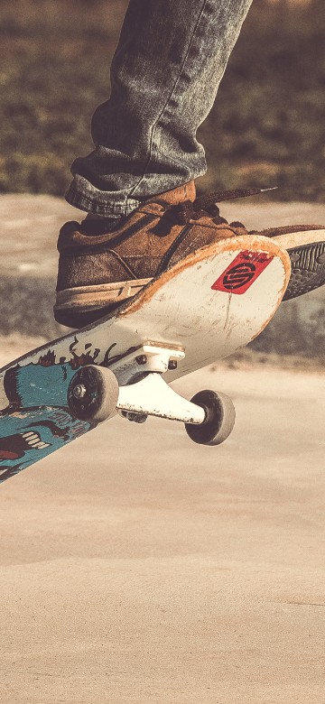 Image person in black pants and blue and white skateboard