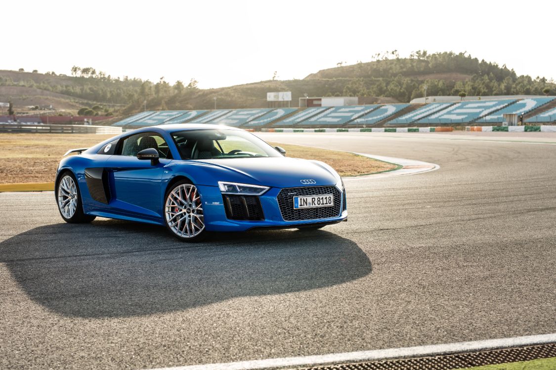 blue audi coupe on gray asphalt road during daytime