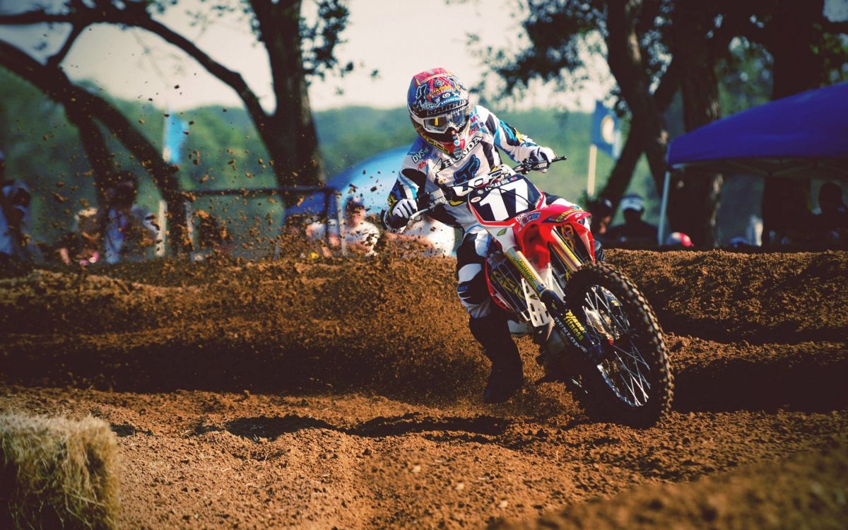 man in blue and white motocross suit riding motocross dirt bike