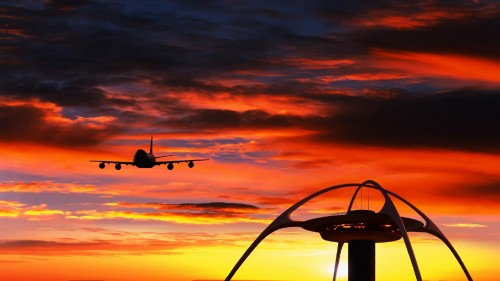 Image airplane flying over the clouds during sunset