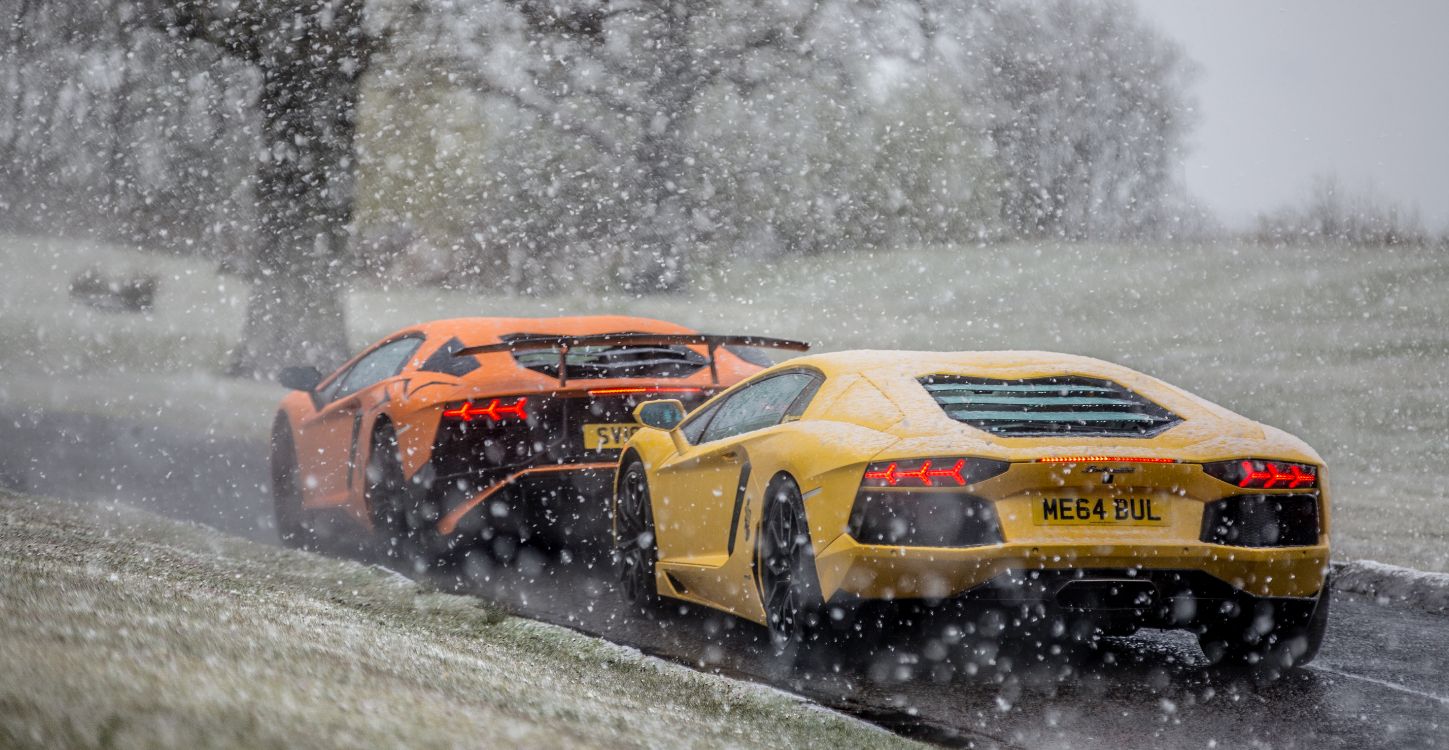 yellow and black sports car on snow covered ground