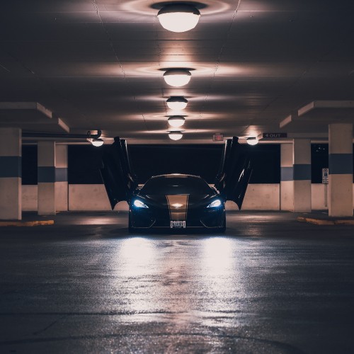 Image blue and black car in a parking lot