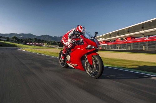 Image man in red motorcycle helmet riding on red sports bike on road during daytime