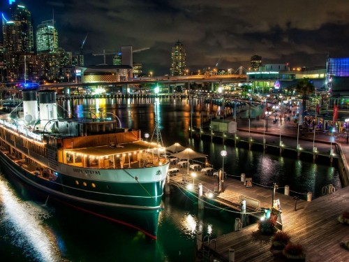 Image white and brown boat on dock during night time