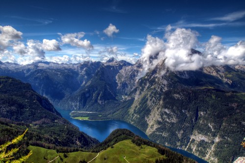 Image green and black mountains under blue sky and white clouds during daytime