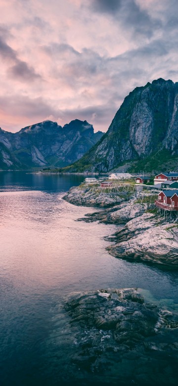 Image body of water near mountain under cloudy sky during daytime
