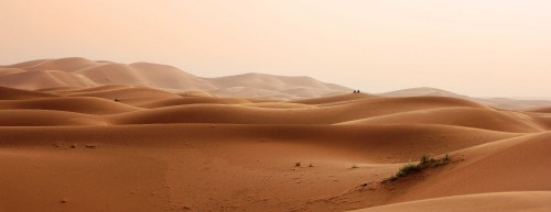 Image person walking on desert during daytime