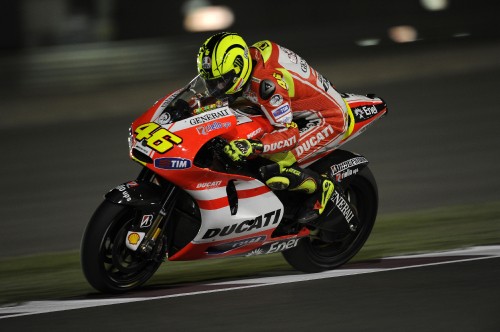 Image man in red and white racing suit riding on sports bike