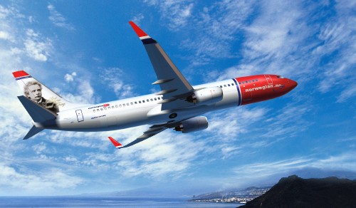 Image white and red airplane flying under blue sky during daytime