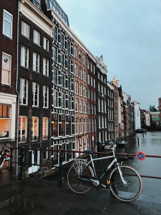 black bicycle parked beside brown concrete building during daytime