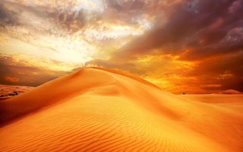 Image brown sand under cloudy sky during daytime