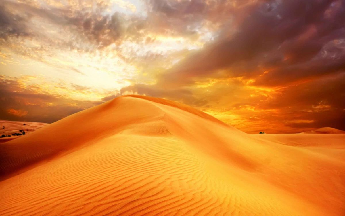 brown sand under cloudy sky during daytime