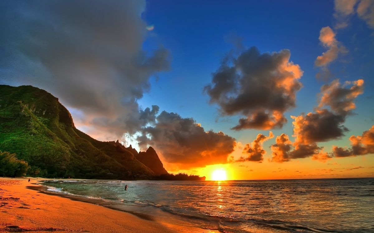 sea waves crashing on shore during sunset