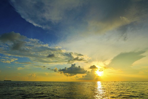 Image body of water under blue sky during sunset