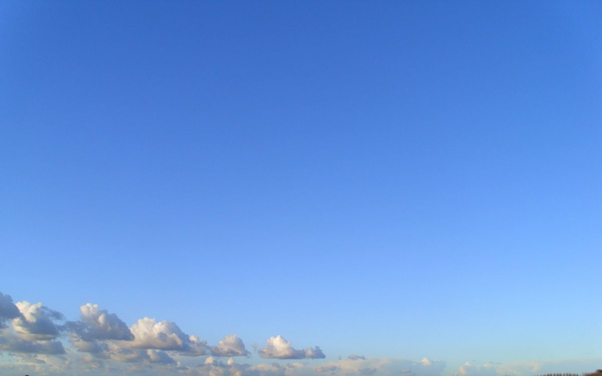 white clouds over snow covered mountains during daytime