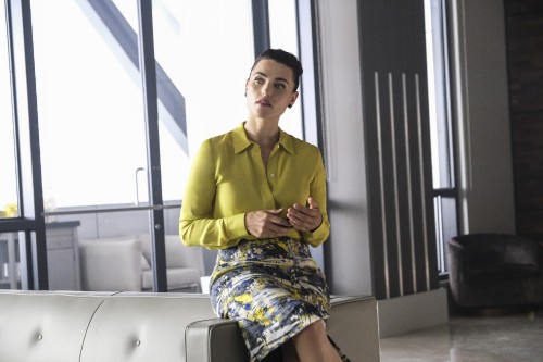 Image woman in yellow long sleeve shirt sitting on white chair