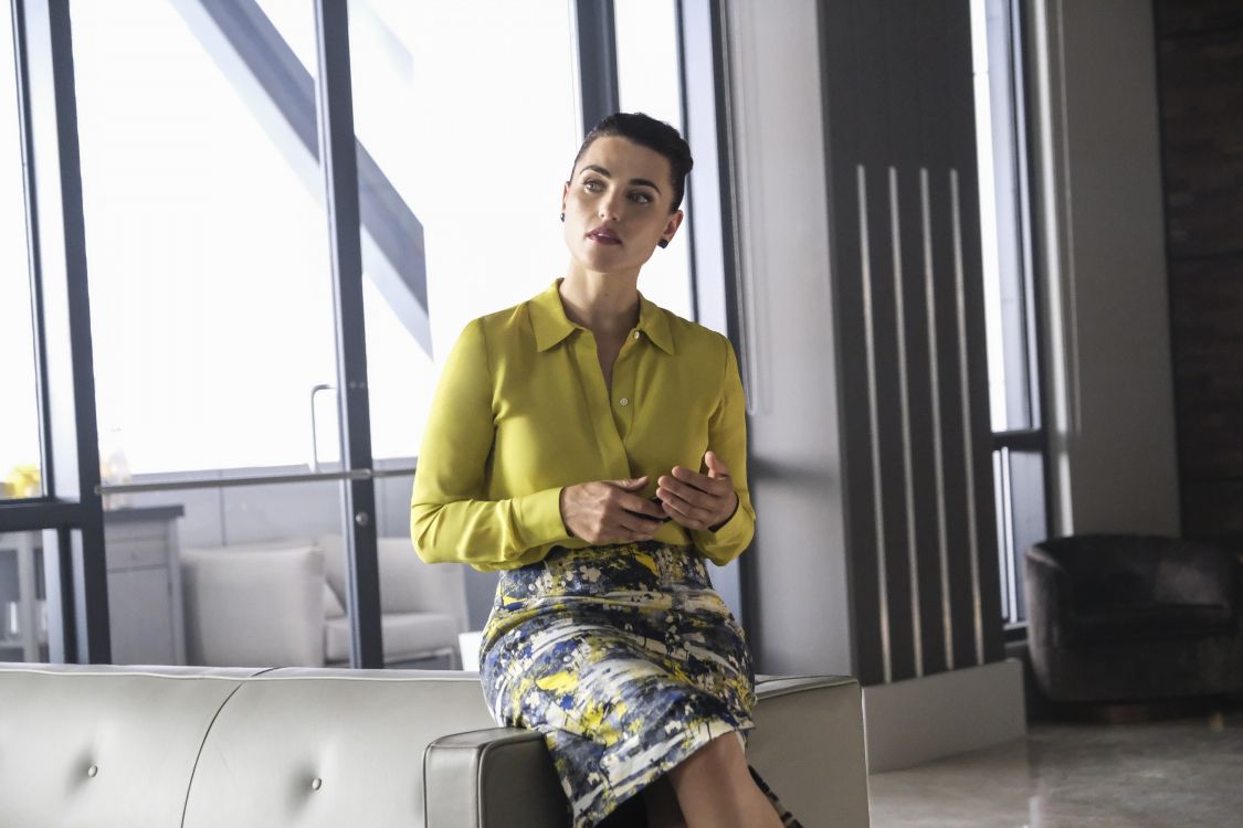 woman in yellow long sleeve shirt sitting on white chair