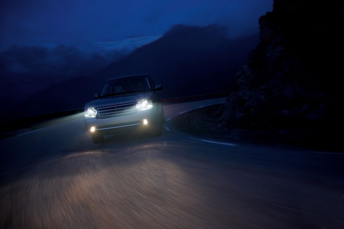 white suv on road during night time