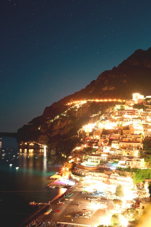 Image white and brown concrete building near body of water during night time