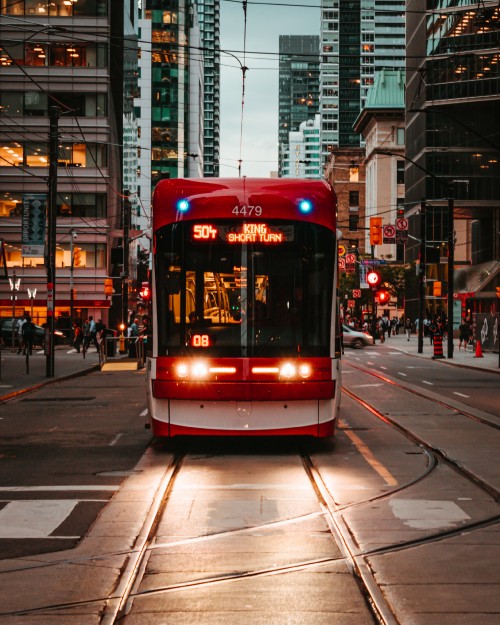 Image red and white tram on road during daytime