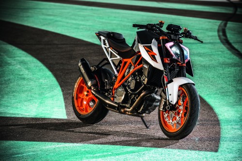 Image orange and black sports bike on gray concrete road