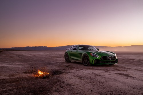 Image green porsche 911 on brown sand during daytime