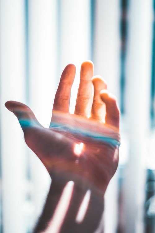 Image persons hand with blue paint