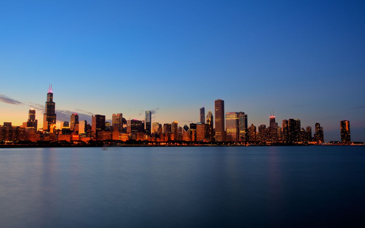 city skyline across body of water during daytime