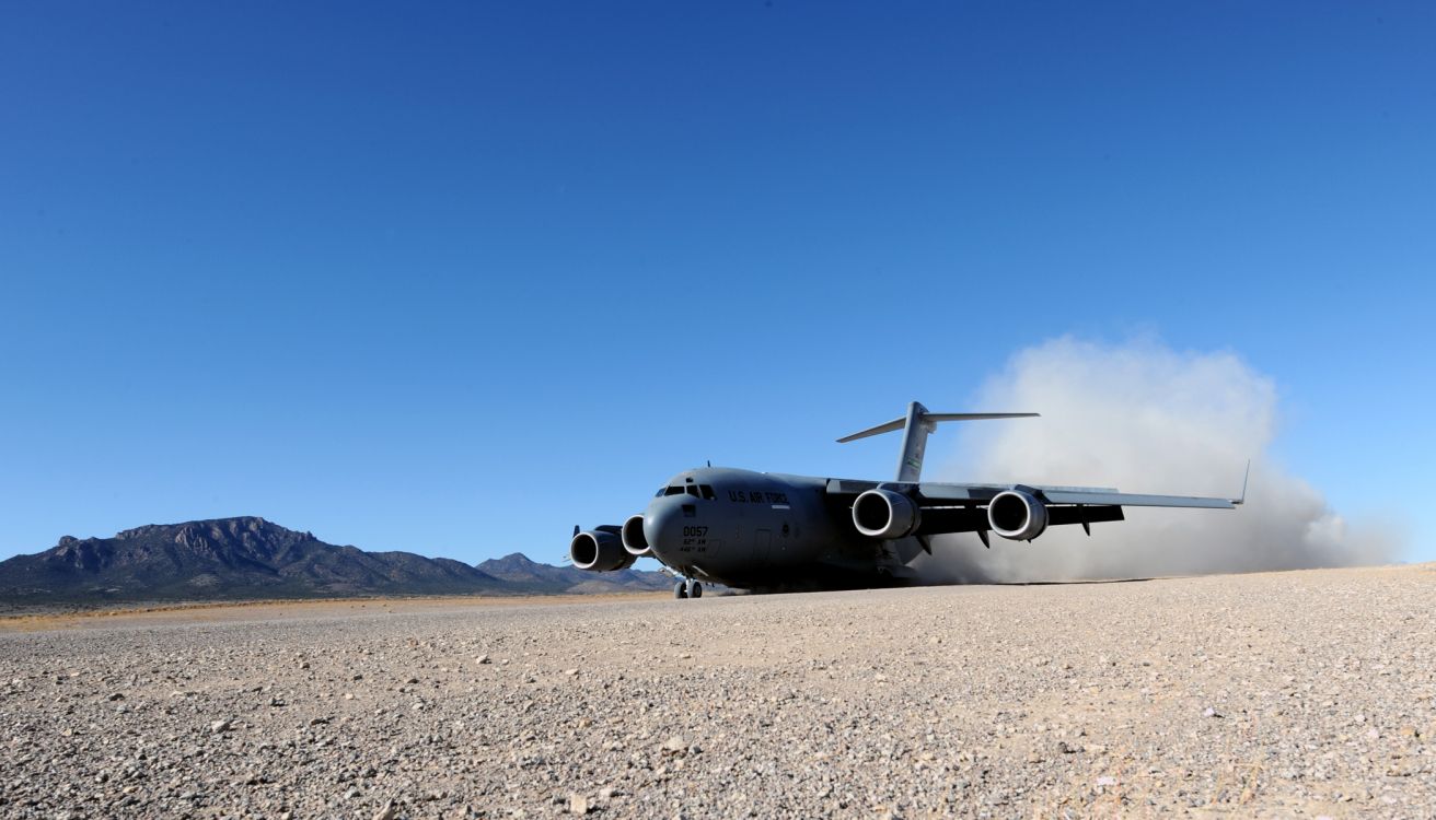 Gray and Black Plane on Brown Sand Under Blue Sky During Daytime. Wallpaper in 2100x1200 Resolution