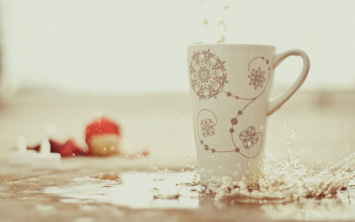 white ceramic mug on white table